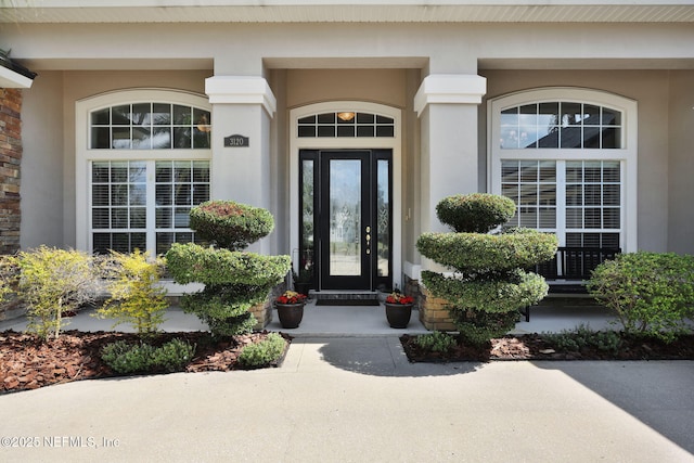 doorway to property with stucco siding