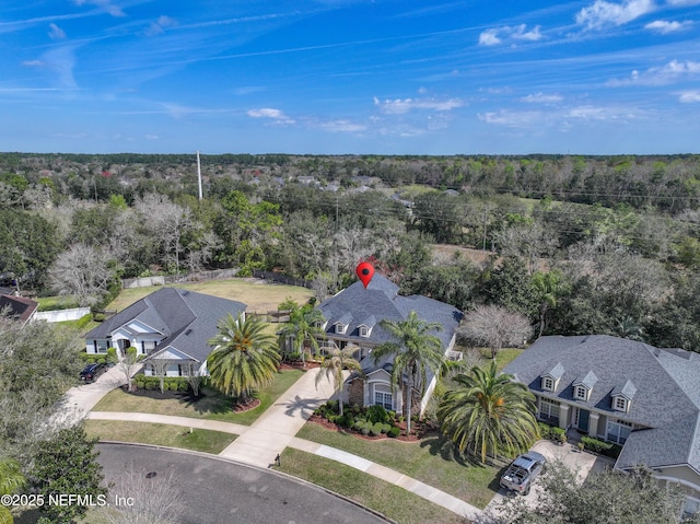 birds eye view of property featuring a wooded view