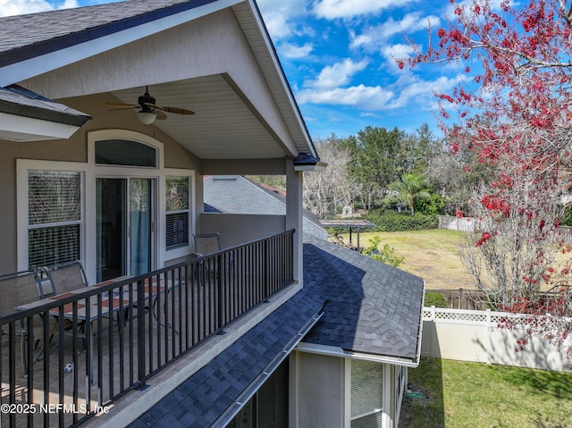 exterior space with ceiling fan, a yard, and fence