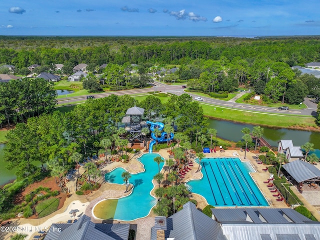 aerial view with a water view and a wooded view