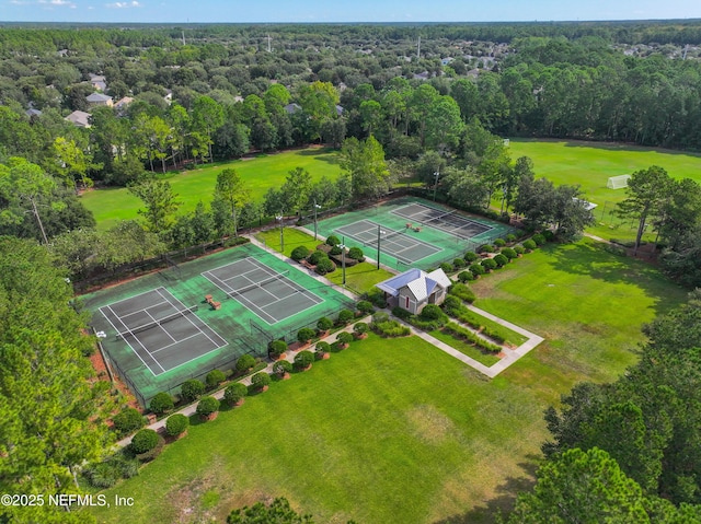 drone / aerial view with a wooded view