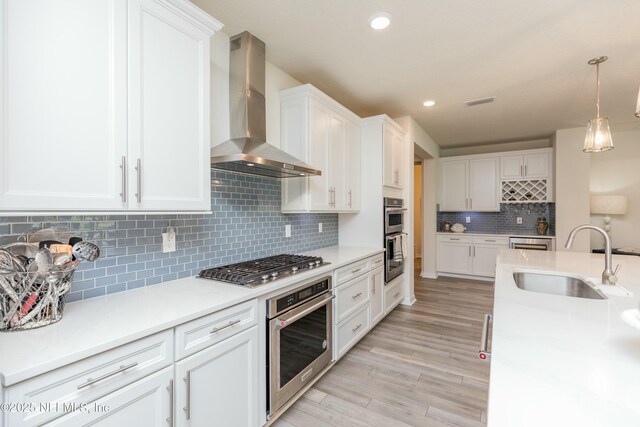 195 Glen Valley Dr, Ponte Vedra, FL 32081 - kitchen with wall chimney range hood, stainless steel gas cooktop, a sink, white cabinets, and recessed lighting