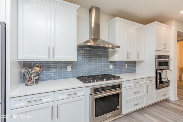 195 Glen Valley Dr, Ponte Vedra, FL 32081 - kitchen with wall chimney exhaust hood, stainless steel appliances, white cabinets, and light countertops