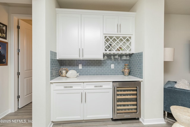 195 Glen Valley Dr, Ponte Vedra, FL 32081 - indoor dry bar with beverage cooler, light wood-style flooring, baseboards, and backsplash