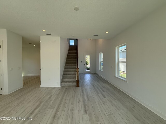 35 Mahogany Way, Palm Coast, FL 32164 - unfurnished living room featuring light hardwood / wood-style floors and a textured ceiling