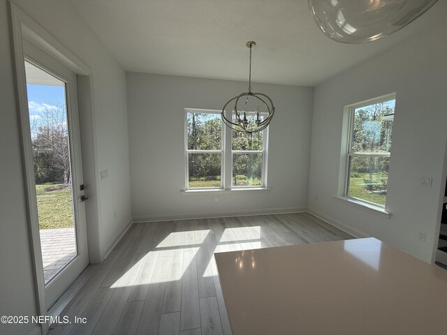35 Mahogany Way, Palm Coast, FL 32164 - unfurnished dining area with an inviting chandelier and light hardwood / wood-style floors