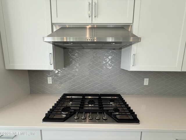 35 Mahogany Way, Palm Coast, FL 32164 - kitchen with gas stovetop, extractor fan, decorative backsplash, and white cabinets