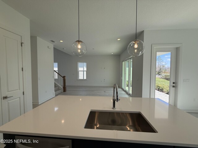 35 Mahogany Way, Palm Coast, FL 32164 - kitchen featuring a kitchen island with sink, sink, and hanging light fixtures
