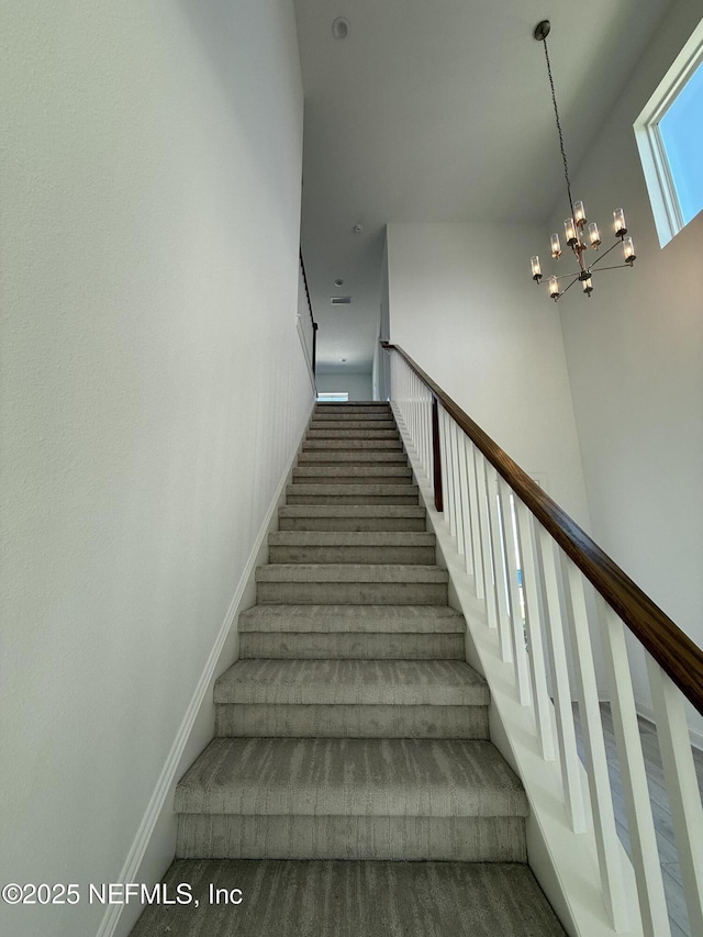 35 Mahogany Way, Palm Coast, FL 32164 - staircase with a chandelier