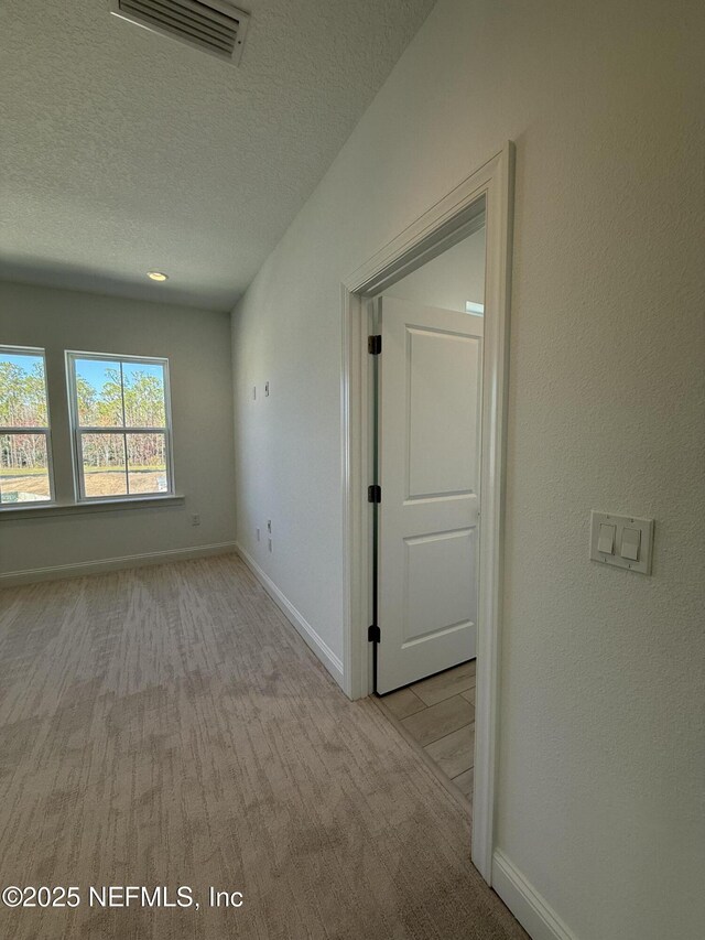 35 Mahogany Way, Palm Coast, FL 32164 - carpeted spare room with a textured ceiling