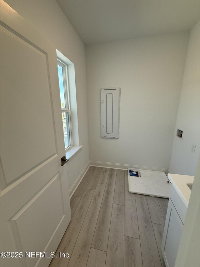 35 Mahogany Way, Palm Coast, FL 32164 - laundry area with cabinets, washer hookup, and light hardwood / wood-style flooring