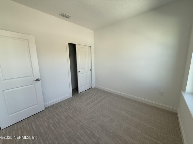 35 Mahogany Way, Palm Coast, FL 32164 - unfurnished bedroom with a closet and a textured ceiling