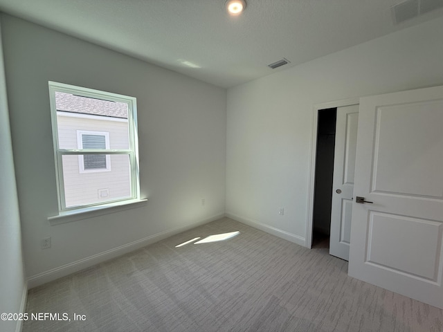 35 Mahogany Way, Palm Coast, FL 32164 - unfurnished bedroom with light carpet and a textured ceiling