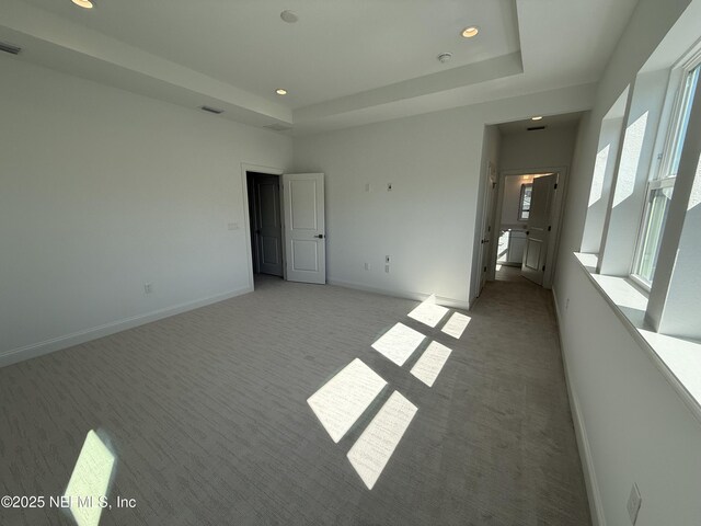 35 Mahogany Way, Palm Coast, FL 32164 - unfurnished bedroom featuring light carpet and a tray ceiling