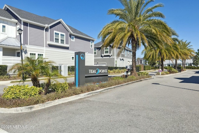 view of street featuring a residential view and curbs