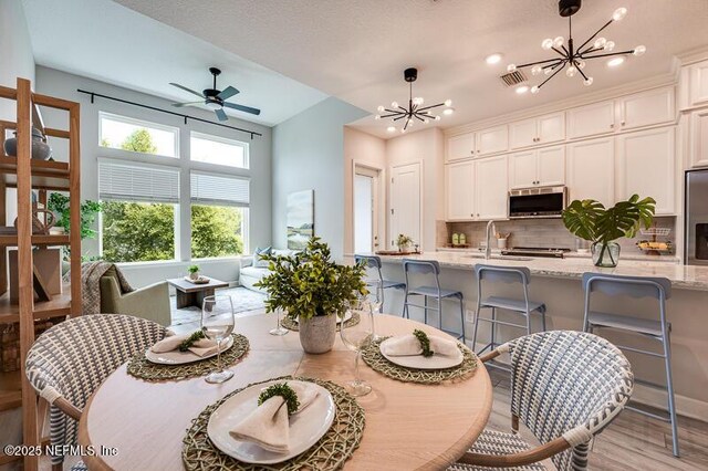 11484 Gully Ct, Jacksonville, FL 32256 - dining room with a chandelier, light wood-type flooring, ceiling fan, and recessed lighting