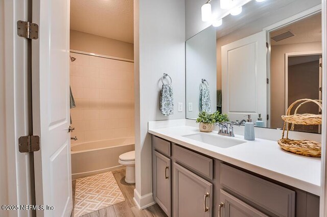11484 Gully Ct, Jacksonville, FL 32256 - full bathroom with vanity, toilet, wood finished floors, and bathtub / shower combination