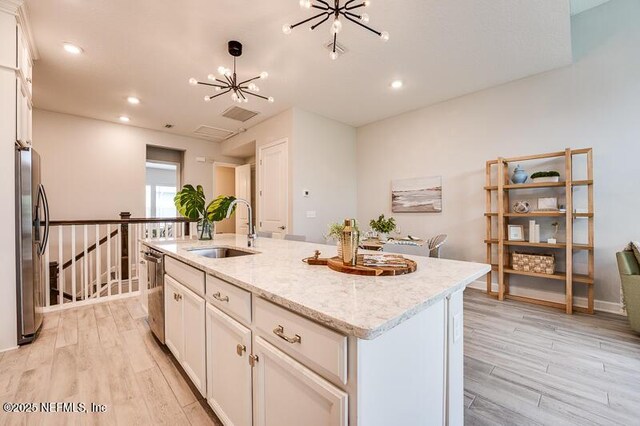 11484 Gully Ct, Jacksonville, FL 32256 - kitchen with a sink, appliances with stainless steel finishes, light wood-style flooring, white cabinetry, and recessed lighting