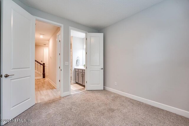 11484 Gully Ct, Jacksonville, FL 32256 - unfurnished bedroom featuring light colored carpet, baseboards, and connected bathroom