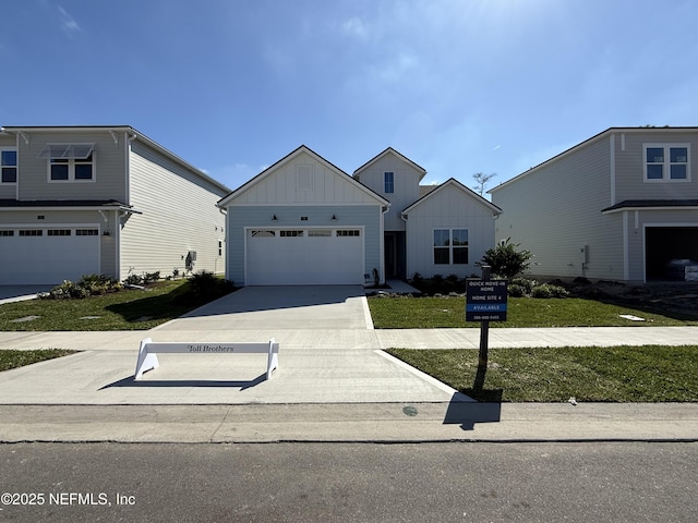 view of front of house featuring a garage and a front lawn