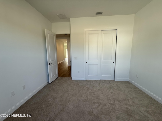 unfurnished bedroom featuring carpet and a closet