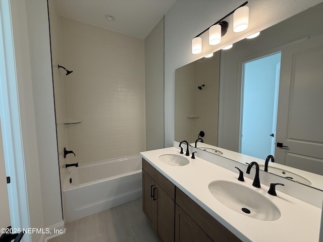 bathroom featuring tiled shower / bath combo, vanity, and tile patterned floors