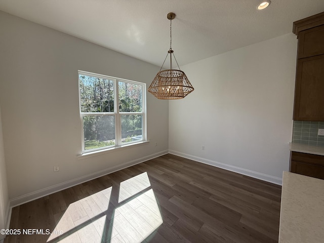 unfurnished dining area with dark hardwood / wood-style flooring