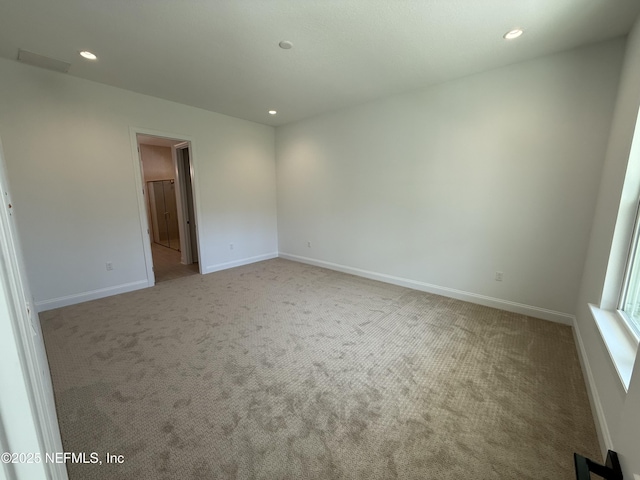 spare room with light colored carpet