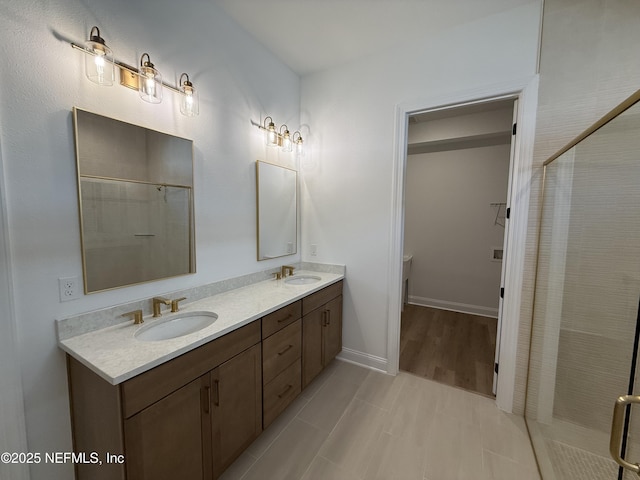 bathroom featuring vanity and an enclosed shower