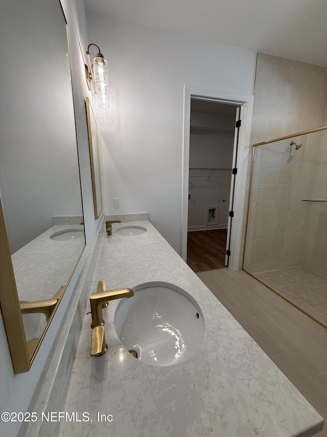 bathroom with vanity and a shower with shower door