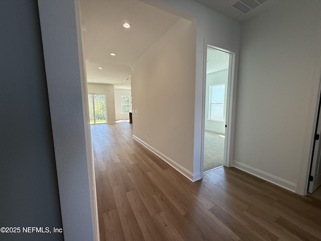 corridor with hardwood / wood-style floors