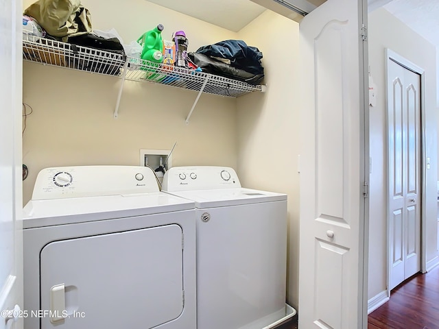 laundry room featuring dark wood-style floors, laundry area, washer and clothes dryer, and baseboards