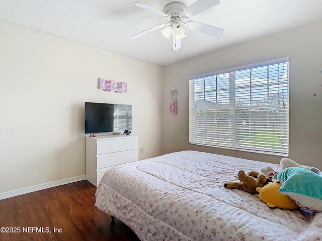 bedroom with ceiling fan, dark wood-style flooring, and baseboards