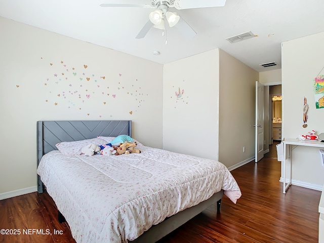 bedroom with visible vents, baseboards, and wood finished floors