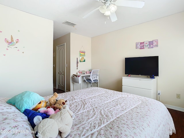 bedroom with dark wood-type flooring, visible vents, baseboards, a ceiling fan, and a closet