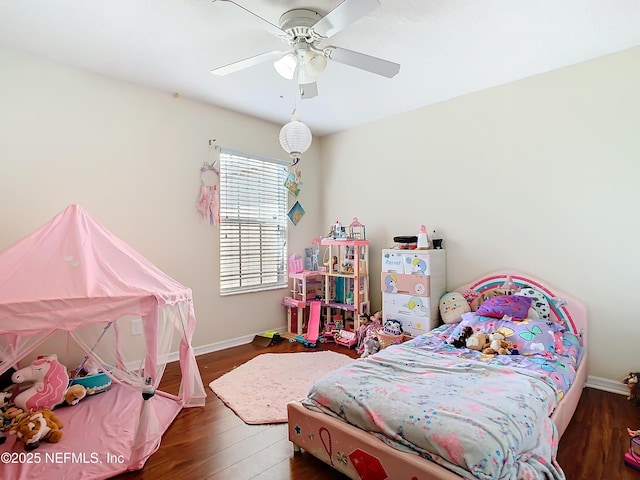 bedroom featuring ceiling fan, baseboards, and wood finished floors