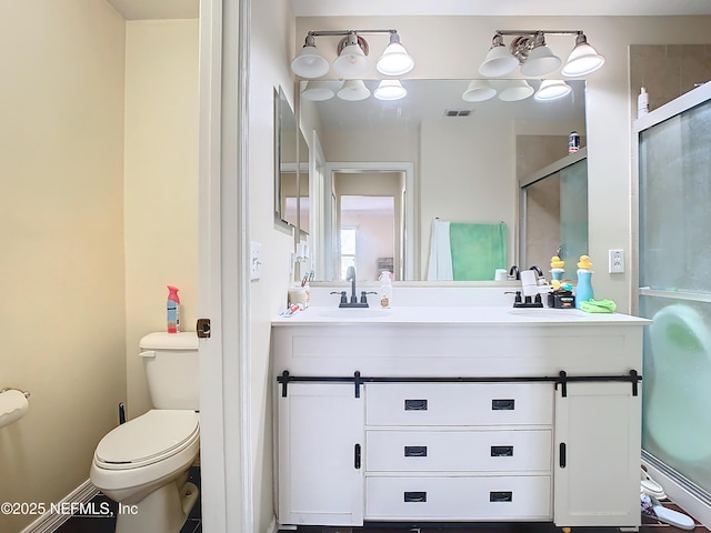 full bathroom with double vanity, a stall shower, visible vents, toilet, and a sink