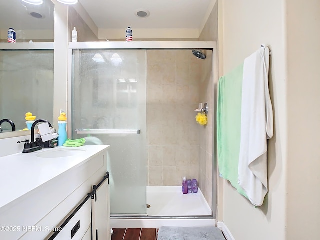 bathroom with a shower stall and vanity