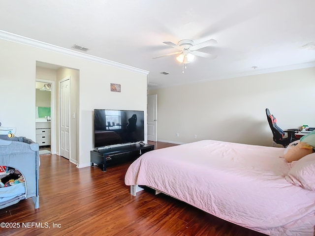 bedroom with baseboards, visible vents, wood finished floors, and ornamental molding