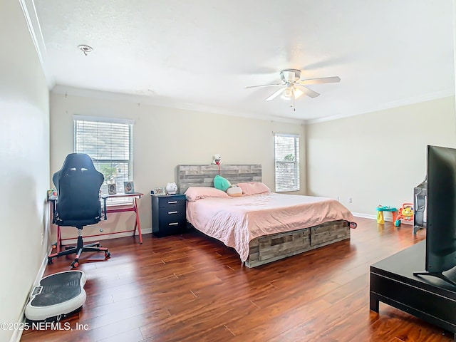 bedroom with crown molding, baseboards, and hardwood / wood-style flooring