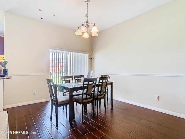 dining area featuring an inviting chandelier, wood tiled floor, and baseboards