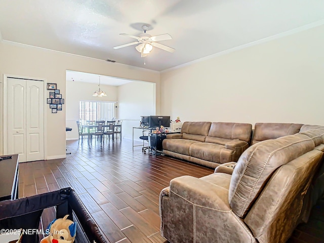 living room with ceiling fan with notable chandelier, baseboards, crown molding, and wood finish floors