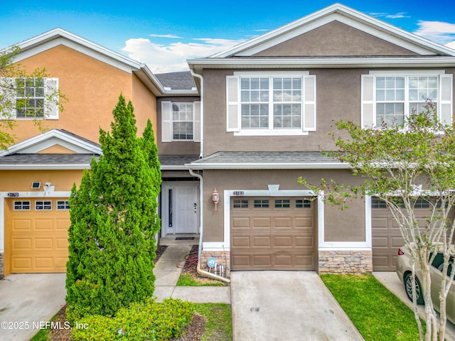 multi unit property featuring driveway and stucco siding