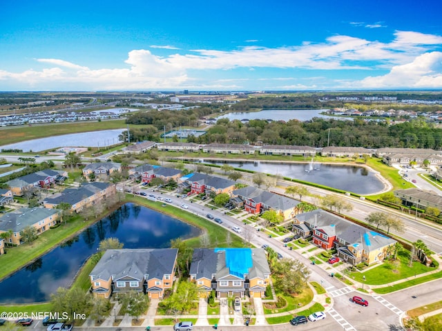 drone / aerial view with a residential view and a water view