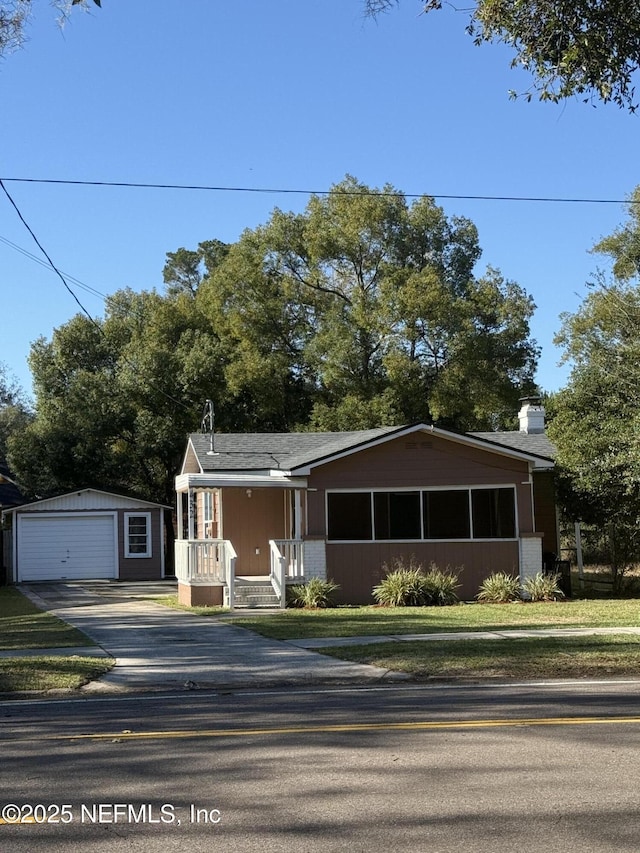 view of front facade with a garage, an outdoor structure, and a porch