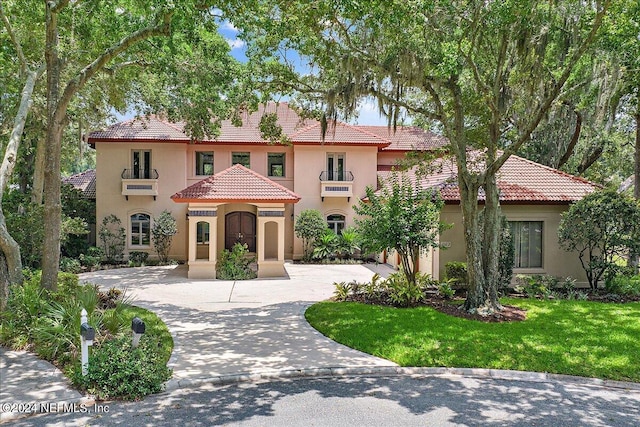 mediterranean / spanish-style house with a front lawn