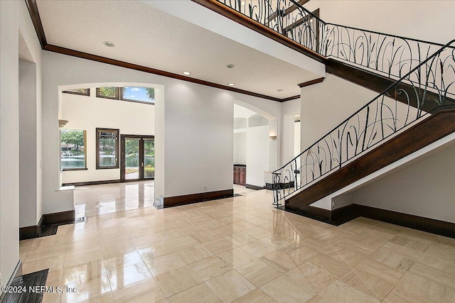13612 Mcqueens Ct, Jacksonville, FL 32225 - entrance foyer with ornamental molding, a towering ceiling, and a textured ceiling