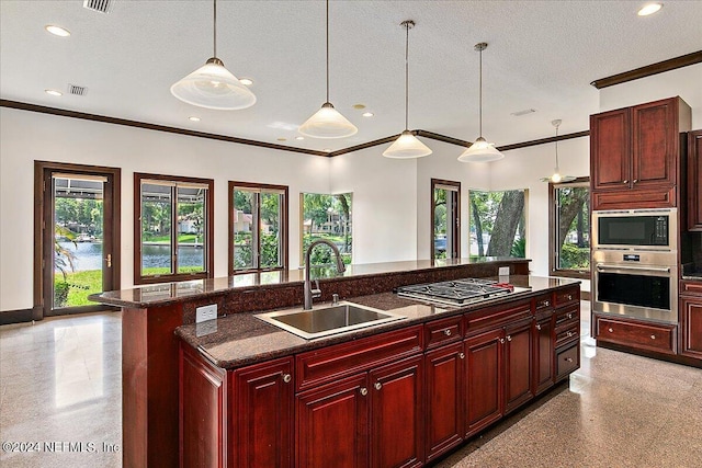 13612 Mcqueens Ct, Jacksonville, FL 32225 - kitchen with sink, a kitchen island with sink, hanging light fixtures, stainless steel appliances, and a textured ceiling