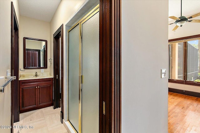 13612 Mcqueens Ct, Jacksonville, FL 32225 - bathroom with ceiling fan, vanity, and an enclosed shower