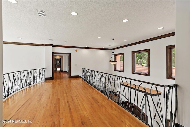 13612 Mcqueens Ct, Jacksonville, FL 32225 - hall with crown molding, hardwood / wood-style floors, and a textured ceiling